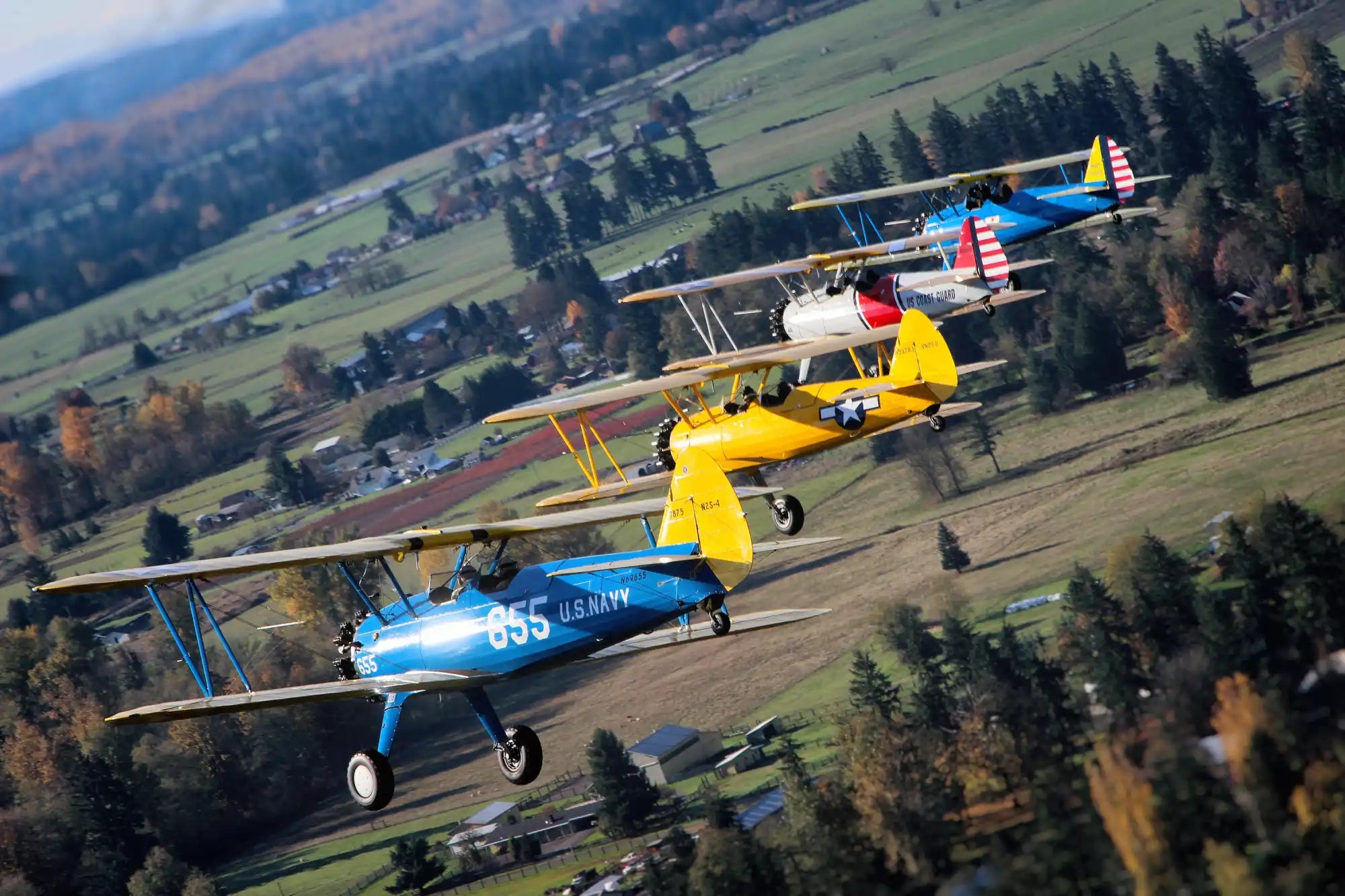 Four biplanes flying in formation.